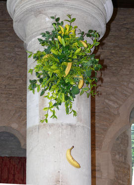 Greenery and a banana on a pillar