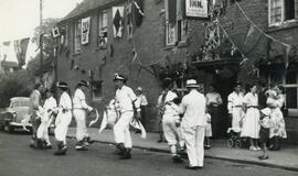 Bertie Clark on fiddle playing for the Bampton Morris outside The New Inn, now renamed The Morris...