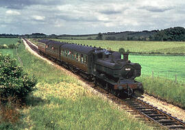 Steam engine and three coaches coming into Brize Norton and Bampton railway station.  Lew Barrow ...