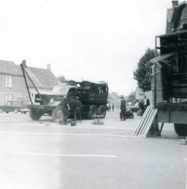 Men beginning to set up one of the rides at the Bampton Fair in the Market Square - 1960s