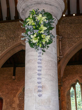 Lilies and column of teabags on a pillar