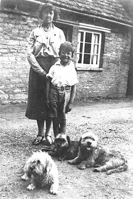 Bill Mathews and mother and dogs, at the back of Dutton's shop
