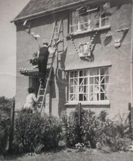 George Dafter putting up the bunting for the Coronation June 1953