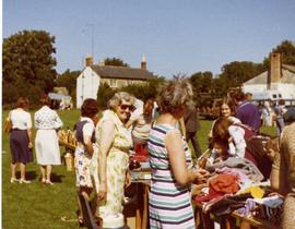 Dora Townsend in yellow dress and sunglasses, Ann Hudson in striped dress