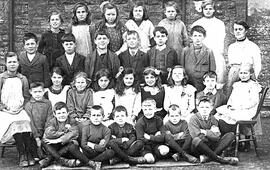 School picture. Miss Hill (teacher) with school children. Miss Hill lived in Melita in Cheapside,